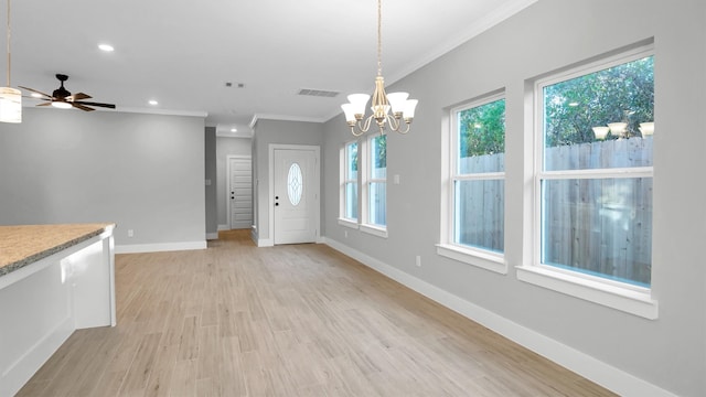 unfurnished dining area with ceiling fan with notable chandelier, light hardwood / wood-style floors, and ornamental molding