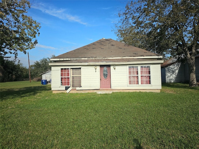 back of property featuring a yard