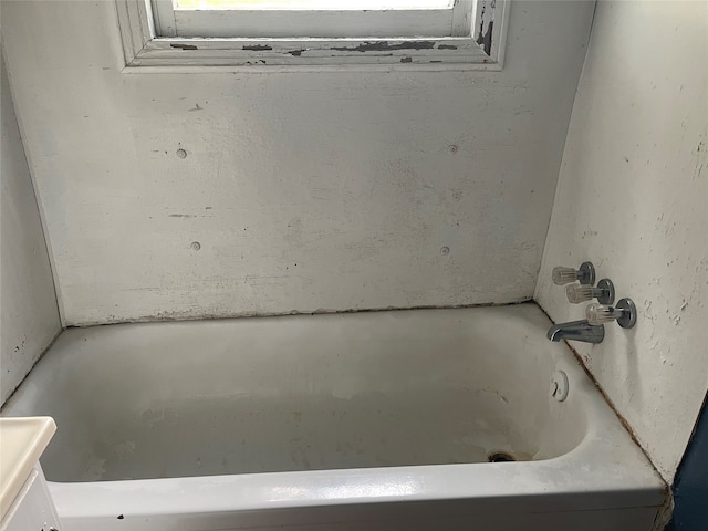 bathroom featuring vanity and a tub