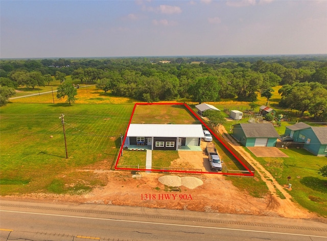 birds eye view of property with a rural view