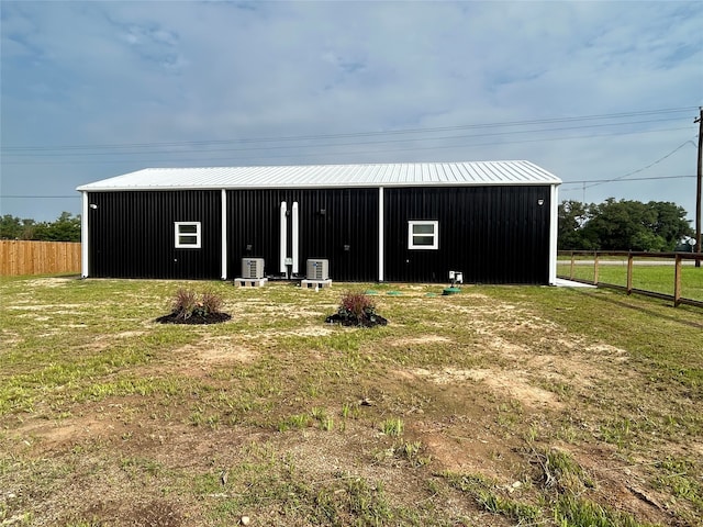 view of outdoor structure featuring a yard and cooling unit