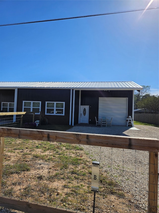 view of front of home with a garage and an outdoor structure