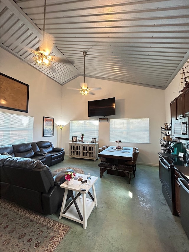 living room featuring ceiling fan, concrete floors, and vaulted ceiling