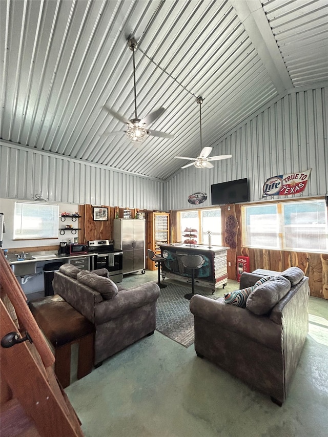 living room with concrete floors, high vaulted ceiling, and ceiling fan