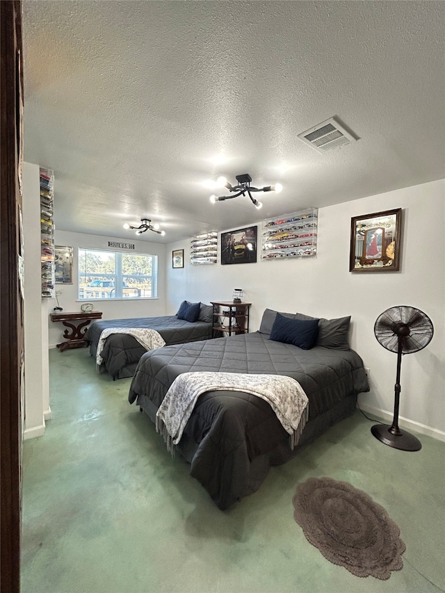 carpeted bedroom with ceiling fan and a textured ceiling