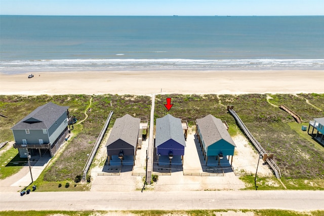 birds eye view of property featuring a water view and a view of the beach