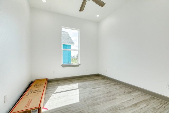 spare room featuring a wealth of natural light, ceiling fan, and light hardwood / wood-style floors