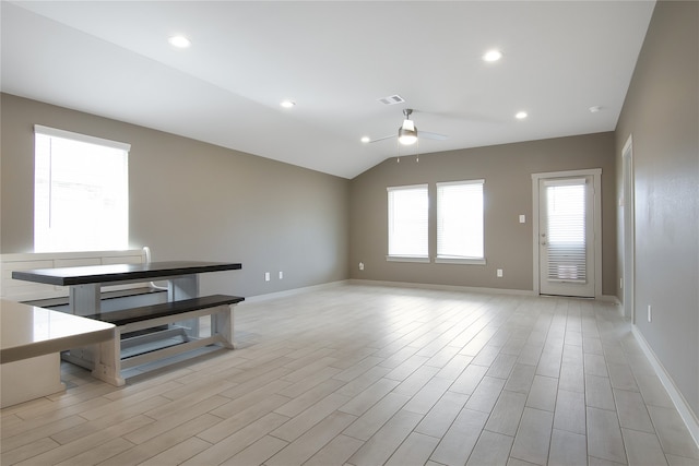 interior space with light hardwood / wood-style floors, ceiling fan, and vaulted ceiling