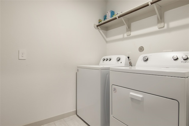 clothes washing area with washer and clothes dryer