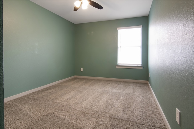 unfurnished room featuring ceiling fan and carpet floors