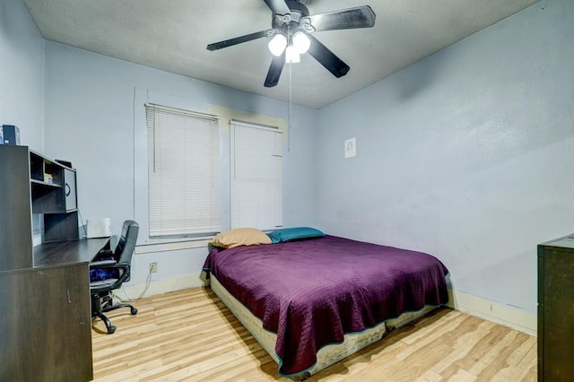 bedroom with light hardwood / wood-style flooring and ceiling fan