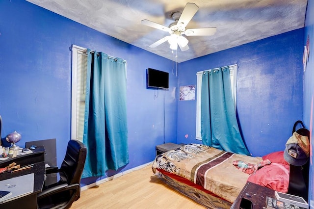 bedroom featuring wood-type flooring and ceiling fan