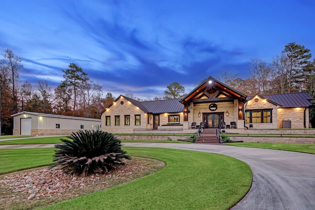 view of front of property featuring a garage and a yard