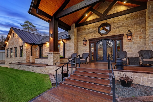 exterior entry at dusk with covered porch