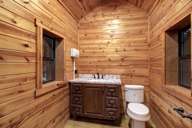 bathroom featuring vaulted ceiling, wooden ceiling, and wood walls