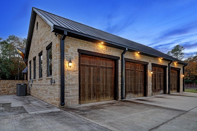 garage at dusk with central AC unit