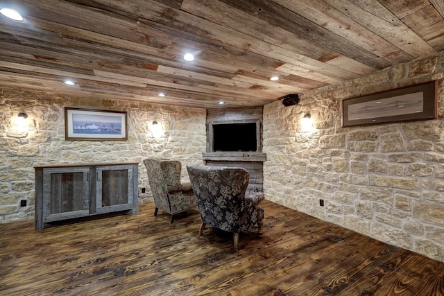 sitting room with dark wood-type flooring and wood ceiling