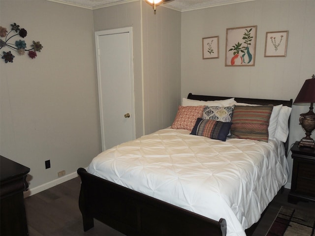 bedroom featuring dark hardwood / wood-style floors and crown molding