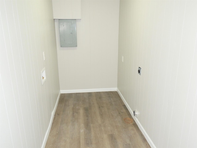 empty room with hardwood / wood-style floors and electric panel