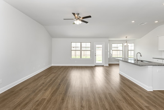 unfurnished living room featuring sink, dark hardwood / wood-style flooring, and ceiling fan