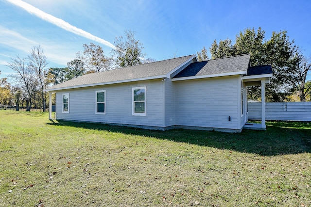 view of side of home with a lawn