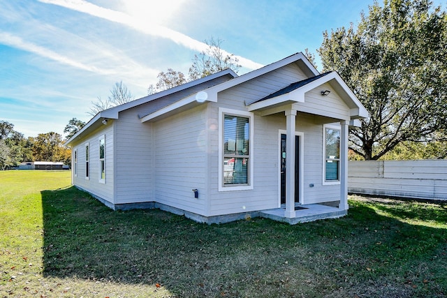 bungalow-style home with a front lawn