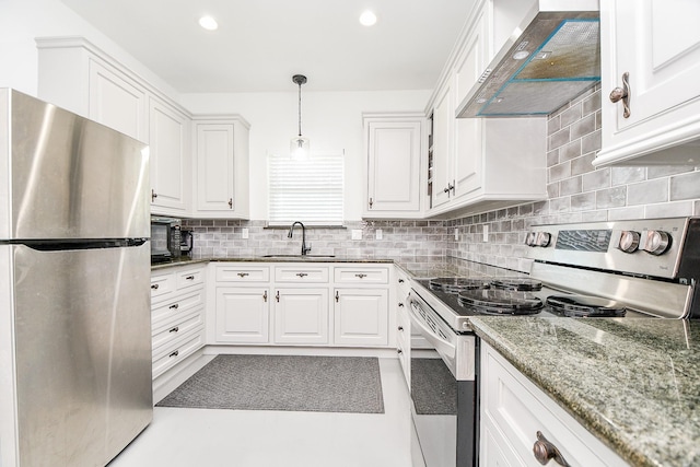 kitchen featuring appliances with stainless steel finishes, white cabinetry, wall chimney exhaust hood, and sink