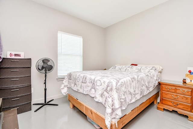 bedroom featuring concrete flooring