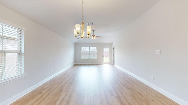 empty room with an inviting chandelier and light hardwood / wood-style floors