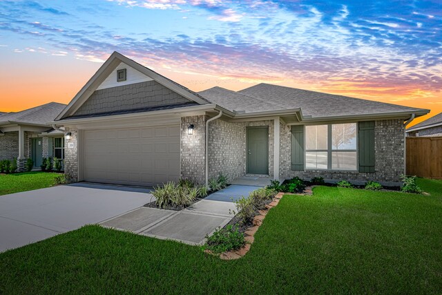 view of front of home featuring a yard and a garage