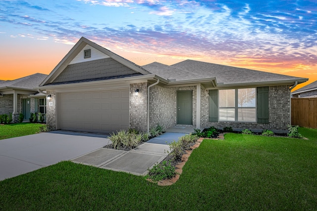 view of front of house with a yard and a garage