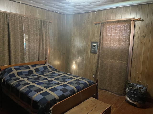 bedroom featuring wood walls and dark wood-type flooring