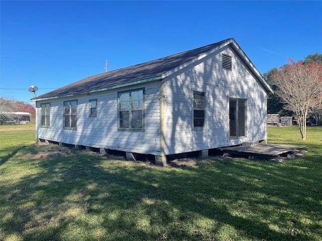 view of side of home featuring a yard