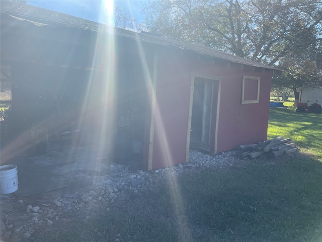 view of outbuilding featuring a yard