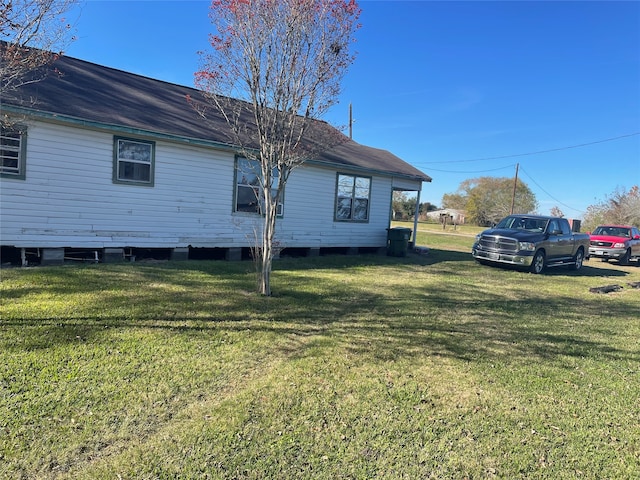 view of side of home featuring a lawn