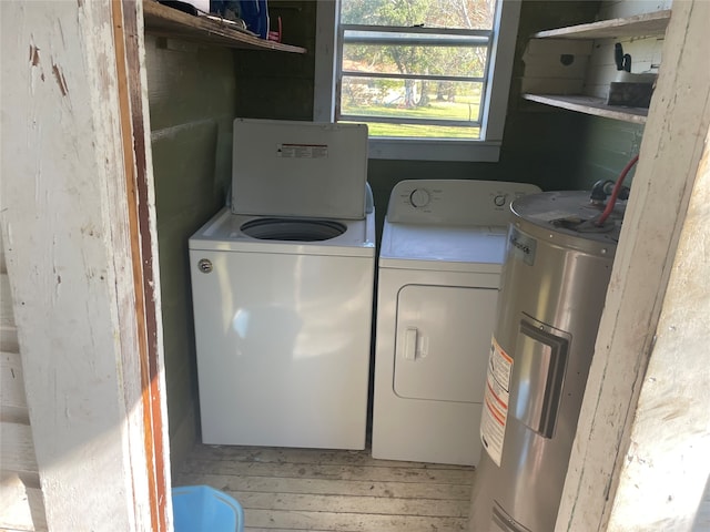 laundry room featuring electric water heater and independent washer and dryer