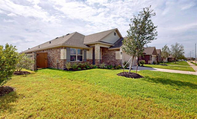 view of front of house with a garage and a front lawn