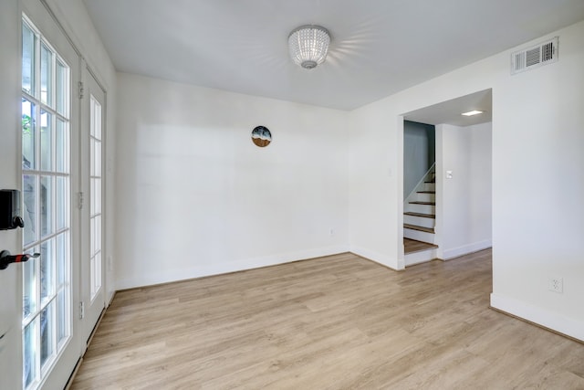 spare room with light hardwood / wood-style flooring