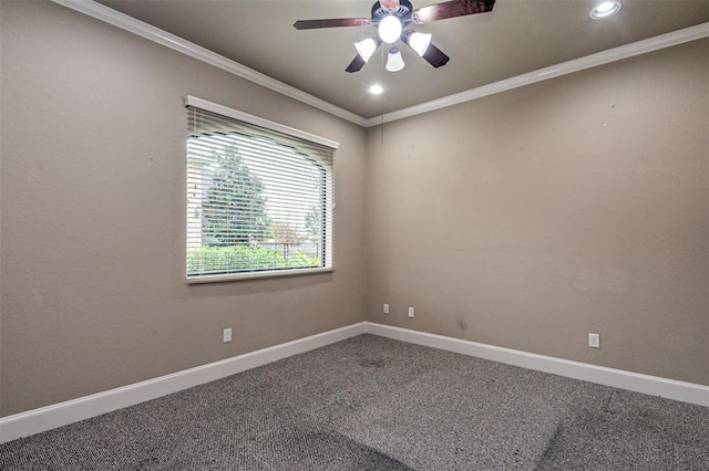 spare room featuring carpet, ceiling fan, and crown molding