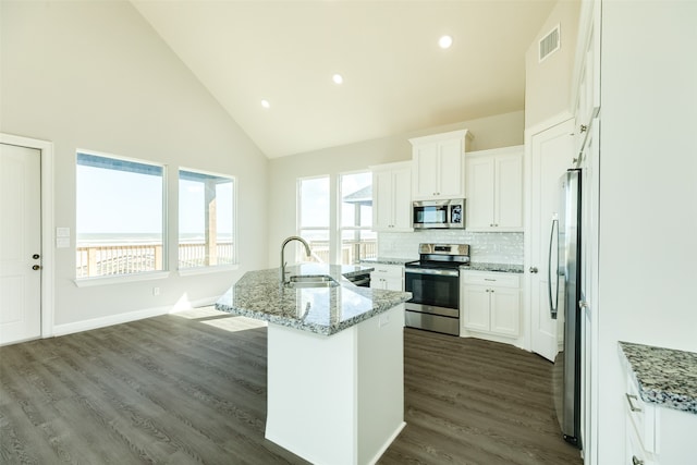 kitchen featuring white cabinets, dark hardwood / wood-style floors, appliances with stainless steel finishes, sink, and tasteful backsplash