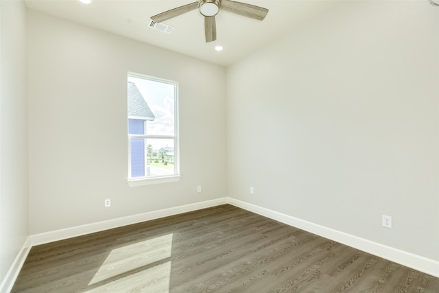 empty room with ceiling fan and dark wood-type flooring