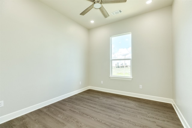 unfurnished room featuring dark hardwood / wood-style flooring and ceiling fan