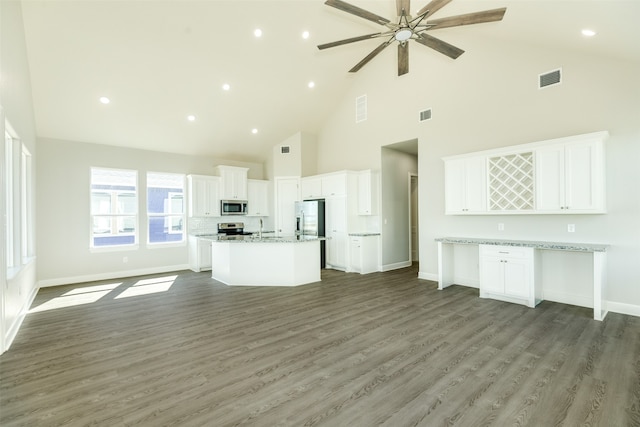 unfurnished living room with ceiling fan, high vaulted ceiling, dark wood-type flooring, and sink