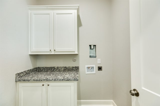 washroom with hookup for a washing machine, hookup for an electric dryer, and cabinets