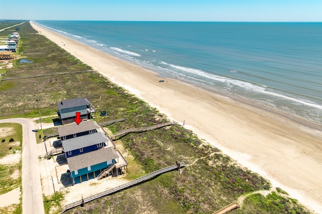 bird's eye view with a water view and a beach view