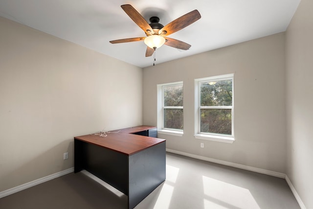 unfurnished office featuring ceiling fan