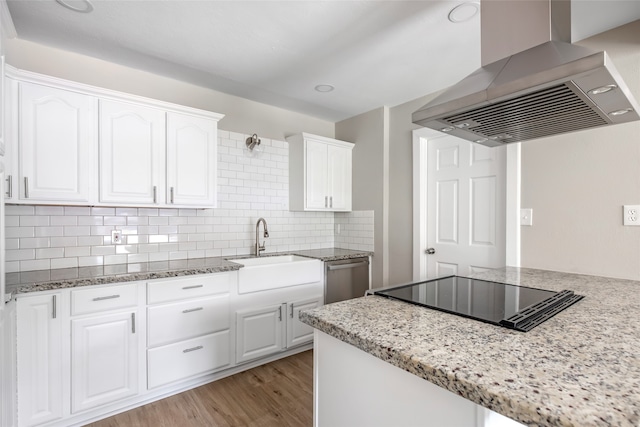 kitchen with island exhaust hood, white cabinetry, light wood-type flooring, black electric cooktop, and dishwasher