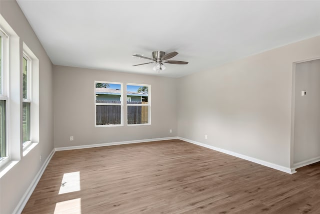 empty room featuring wood-type flooring and ceiling fan