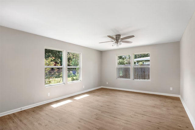 spare room featuring light wood-type flooring and ceiling fan