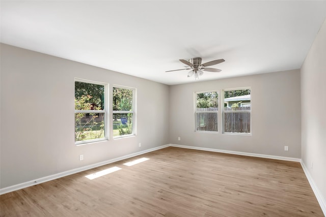 131 County Road 2364, Hardin, TX 77575 - unfurnished room featuring plenty of natural light, ceiling fan, baseboards, and light wood-style floors
